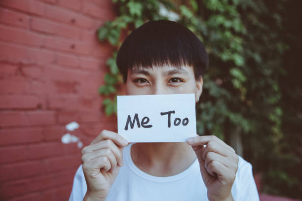 Female showing a note with the text me too A girl showing a note with the text me too in Beijing,China. me too social movement stock pictures, royalty-free photos & images