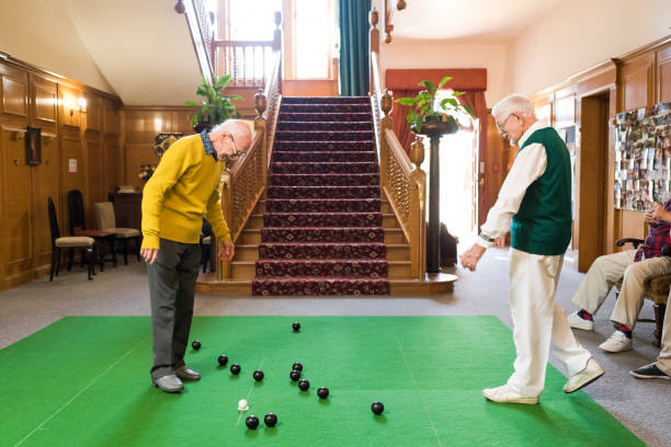 istock Senior man inspecting the bowling balls during a game 1007679228