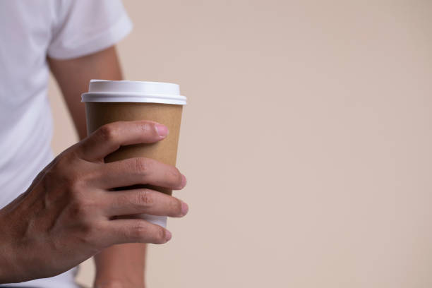 istock Hand holding a paper cup of coffee. 1007682060