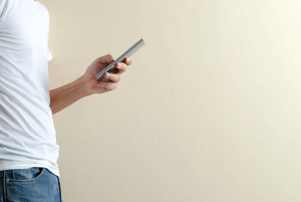 istock The man on white t-shirt using smartphone 1007682354