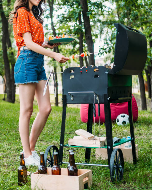 istock partial view of woman taking vegetables from grill in park 1007701258