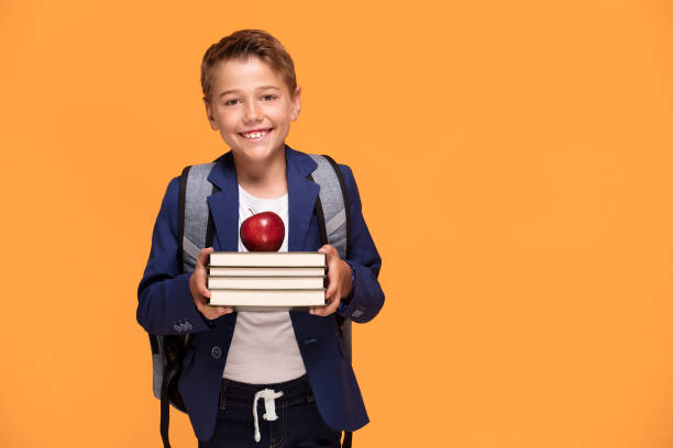 istock Little school boy with backpack and books. 1007701586