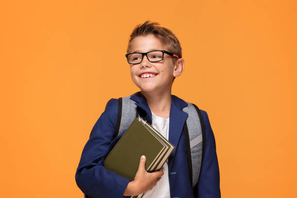 istock Little school boy with backpack and books. 1007701616