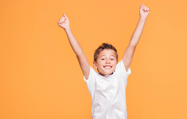 istock Little boy jumping in the studio, smiling. 1007701816