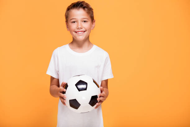 istock Happy little boy with soccer ball. 1007704616