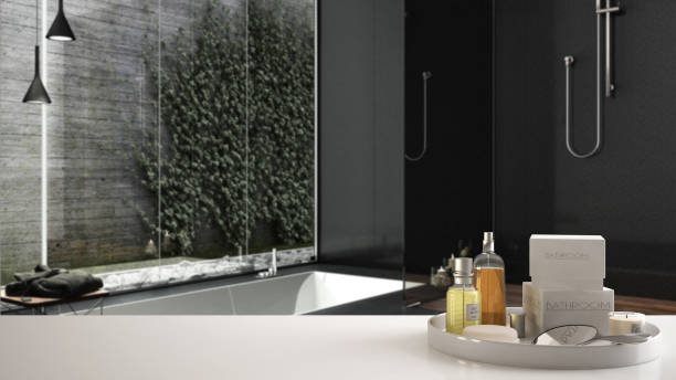 istock Spa, hotel bathroom concept. White table top or shelf with bathing accessories, toiletries, over blurred gray minimalist bathroom, modern architecture interior design 1007705330