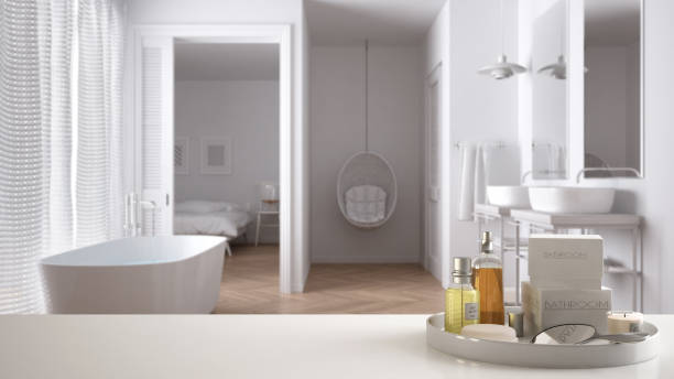 istock Spa, hotel bathroom concept. White table top or shelf with bathing accessories, toiletries, over blurred classic bathroom, modern architecture interior design 1007706114