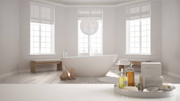 istock Spa, hotel bathroom concept. White table top or shelf with bathing accessories, toiletries, over blurred classy minimalist bathroom, modern architecture interior design 1007706160
