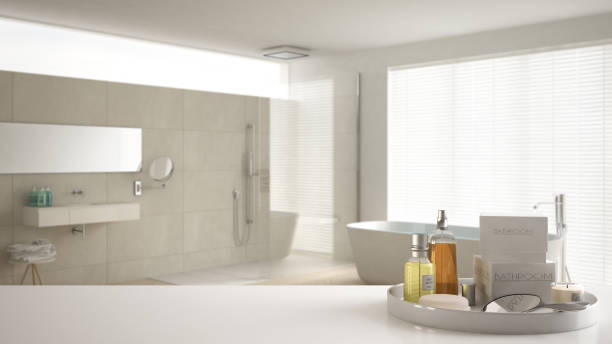 istock Spa, hotel bathroom concept. White table top or shelf with bathing accessories, toiletries, over blurred cream minimalist bathroom, modern architecture interior design 1007706184