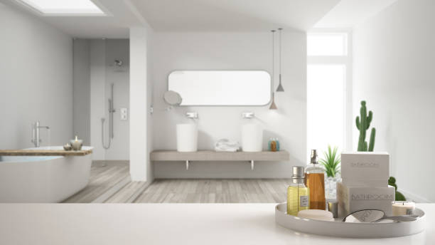 istock Spa, hotel bathroom concept. White table top or shelf with bathing accessories, toiletries, over blurred minimalist bathroom, modern architecture interior design 1007706372