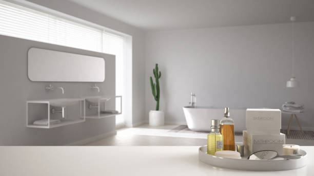 istock Spa, hotel bathroom concept. White table top or shelf with bathing accessories, toiletries, over blurred minimalist bathroom, modern architecture interior design 1007706494