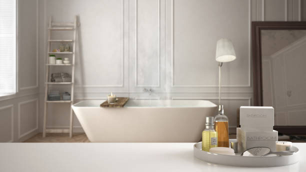 istock Spa, hotel bathroom concept. White table top or shelf with bathing accessories, toiletries, over blurred scandinavian bathroom, modern architecture interior design 1007708892