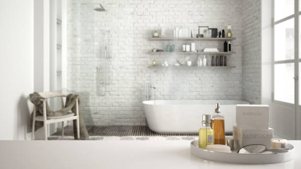 istock Spa, hotel bathroom concept. White table top or shelf with bathing accessories, toiletries, over blurred vintage classic bathroom, modern architecture interior design 1007708998