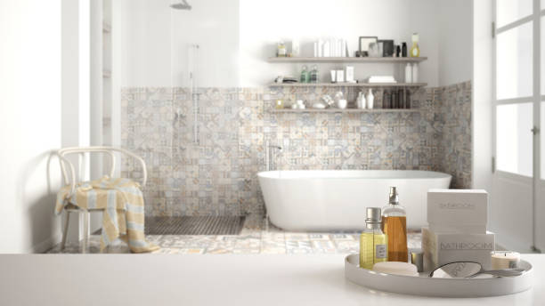 istock Spa, hotel bathroom concept. White table top or shelf with bathing accessories, toiletries, over blurred vintage classic bathroom, modern architecture interior design 1007709054