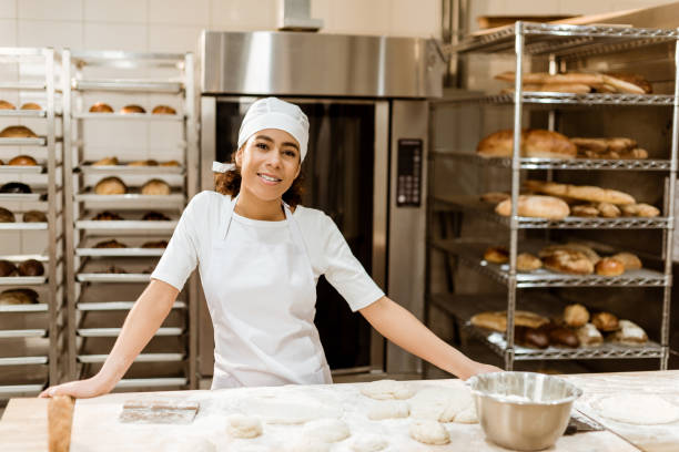 istock female baker standing at workplace on baking manufacture 1007709850