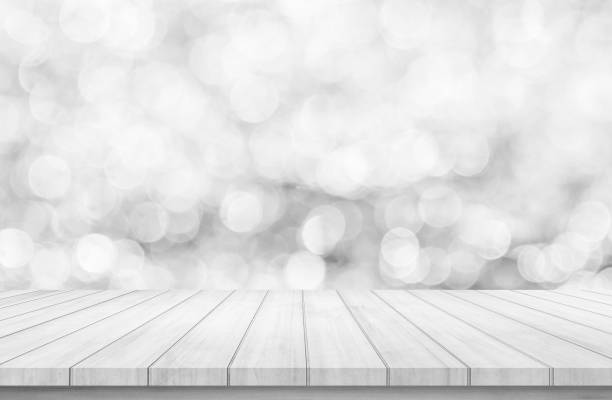 istock Wood table or wood floor with abstract white bokeh background for product display 1007710366
