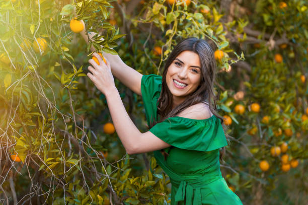 istock Young woman, outdoors at sunset in a orange orchard 1007713996