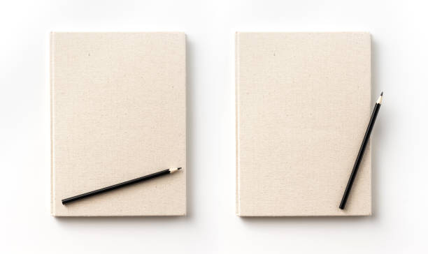istock Top view collection of  light yellow fabric notebook front, back , pen and white open page isolated on background for mockup 1007714004