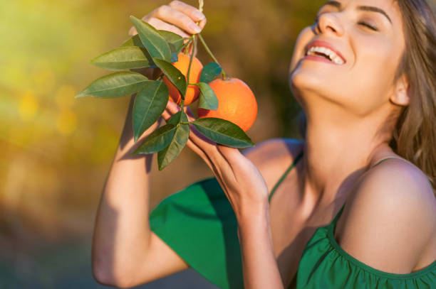 istock Joyful young woman, outdoors at sunset in a orange orchard 1007716676