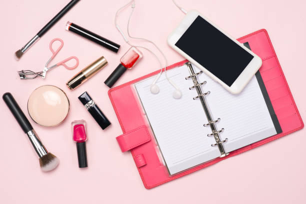 istock Make up or visage background. Blank page notepad and different cosmetic accessories in the holder with copy space. 1007720330