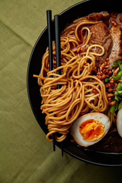 istock Japanese ramen with pork belly, mushrooms and marinated eggs on green linen tablecloth 1007721062