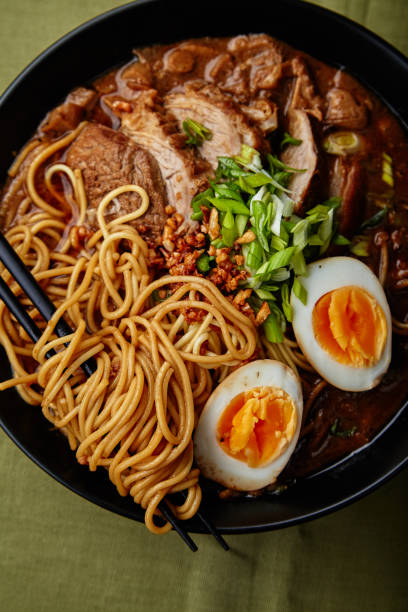 istock Japanese ramen with pork belly, mushrooms and marinated eggs on green linen tablecloth 1007722154