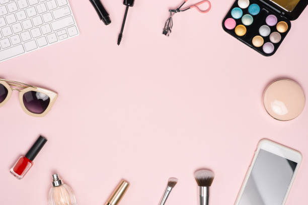 istock Workspace with laptop, paper clips, bookmarks, make-up brushes, powder. Top view with copy space 1007722938