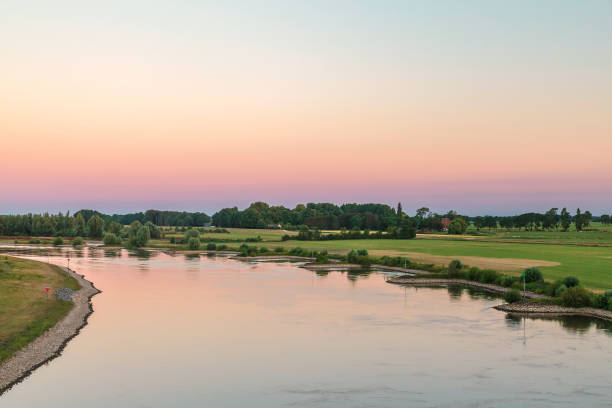 The old Dutch river IJssel in the province of Gelderland near the city of Zutphen The old Dutch river IJssel in the province of Gelderland near the city of Zutphen during sunset ijssel photos stock pictures, royalty-free photos & images