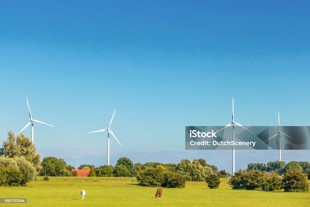 Dutch farmland with four windmills in Gelderland near Arnhem Dutch farmland with four windmills in Gelderland near Arnhem, The Netherlands Wind Turbine Stock Photo