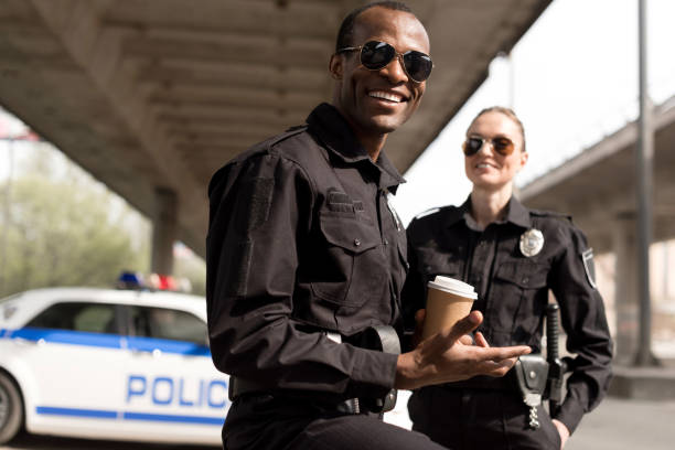 istock happy young police officers having coffee break 1007726000