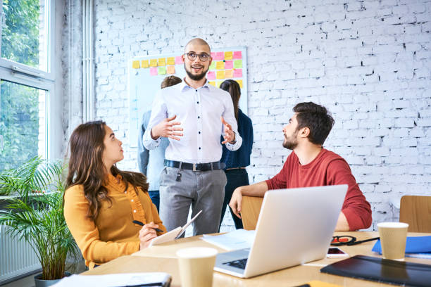 istock Group of students discussing and studying together in classroom. Startup businesspeople during meeting 1007726842