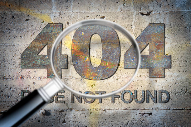 istock Searching dead link - concept image over an old stone wall seen through a magnifying glass 1007736828