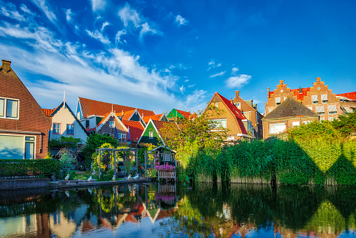 A traditional Dutch village with colorful, old wooden houses, brigdes and canals