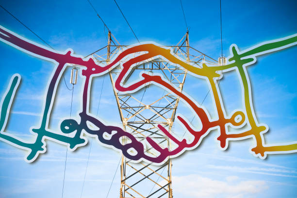 istock Power tower and transmission lines on blue background with handshake for a done deal 1007740030