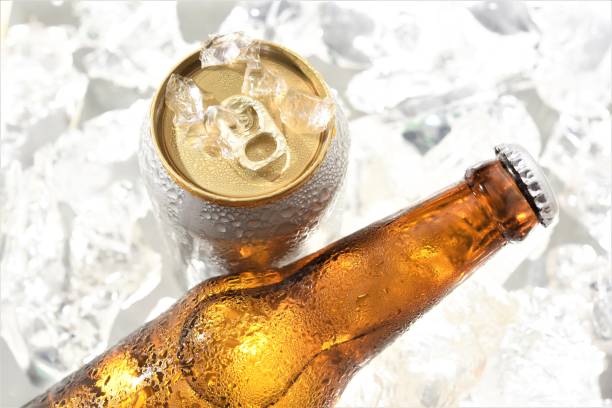 beer bottle and can chilled in ice - beer cans imagens e fotografias de stock