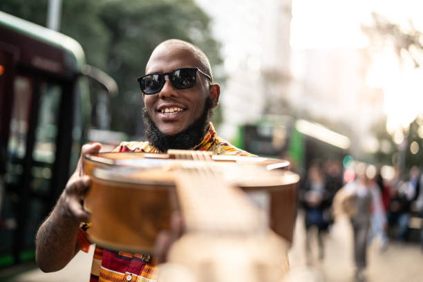 istock Afro descent hipster man with guitar outdoors 1007749796