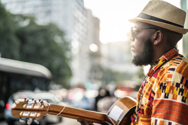 istock Afro descent hipster man with guitar outdoor 1007753666