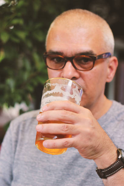 istock Young bearded man drinking beer with Mature Man 1007753956