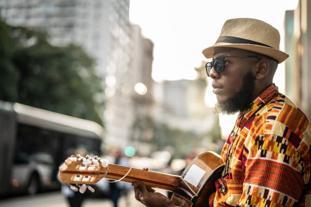 istock Afro descent hipster man with guitar outdoor 1007754000