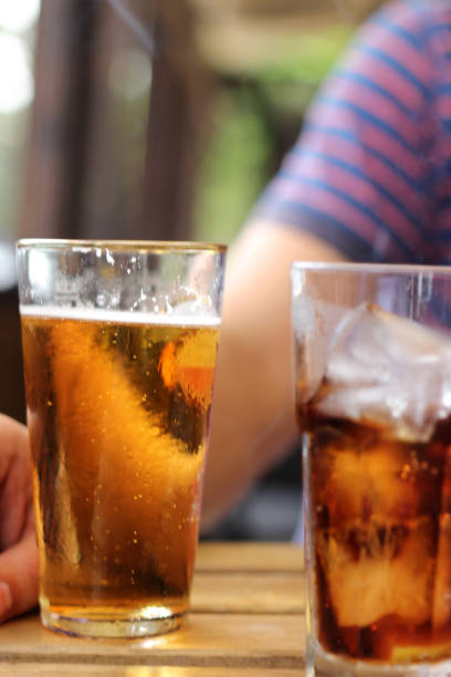 istock Young bearded man drinking beer with Mature Man 1007754016