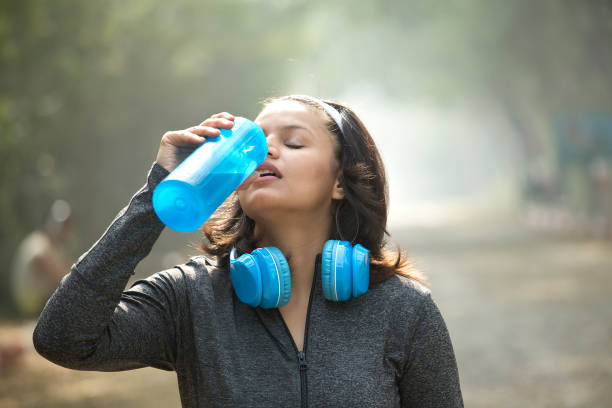 istock Woman drinking water after jogging 1007757208