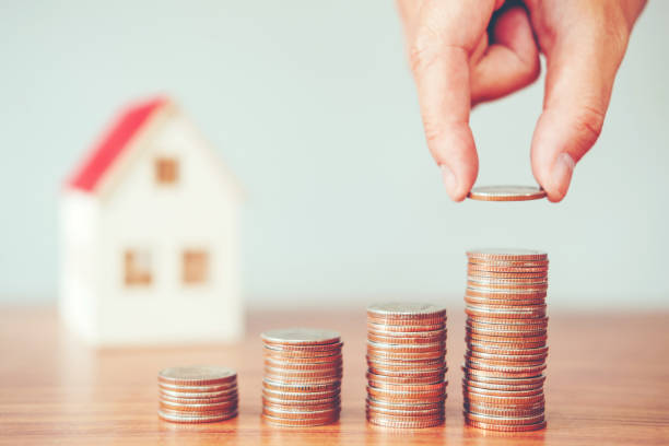 istock Saving money concept man hand putting coin stack finance for budget 1007757232