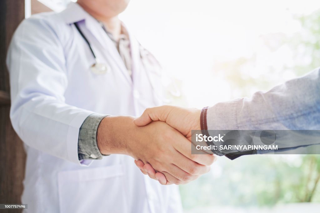 Confident  Doctor shaking hands with patients talk in the hospital Doctor Stock Photo