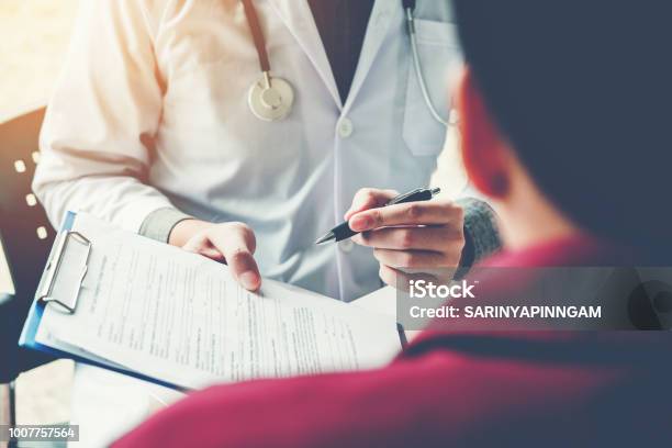 Doctors And Patients Sit And Talk At The Table Near The Window In The Hospital Stock Photo - Download Image Now