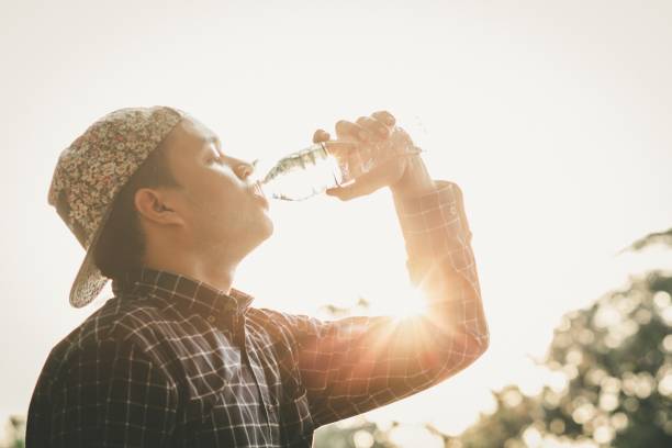 istock Young man thirsty Drink bottled water 1007757586