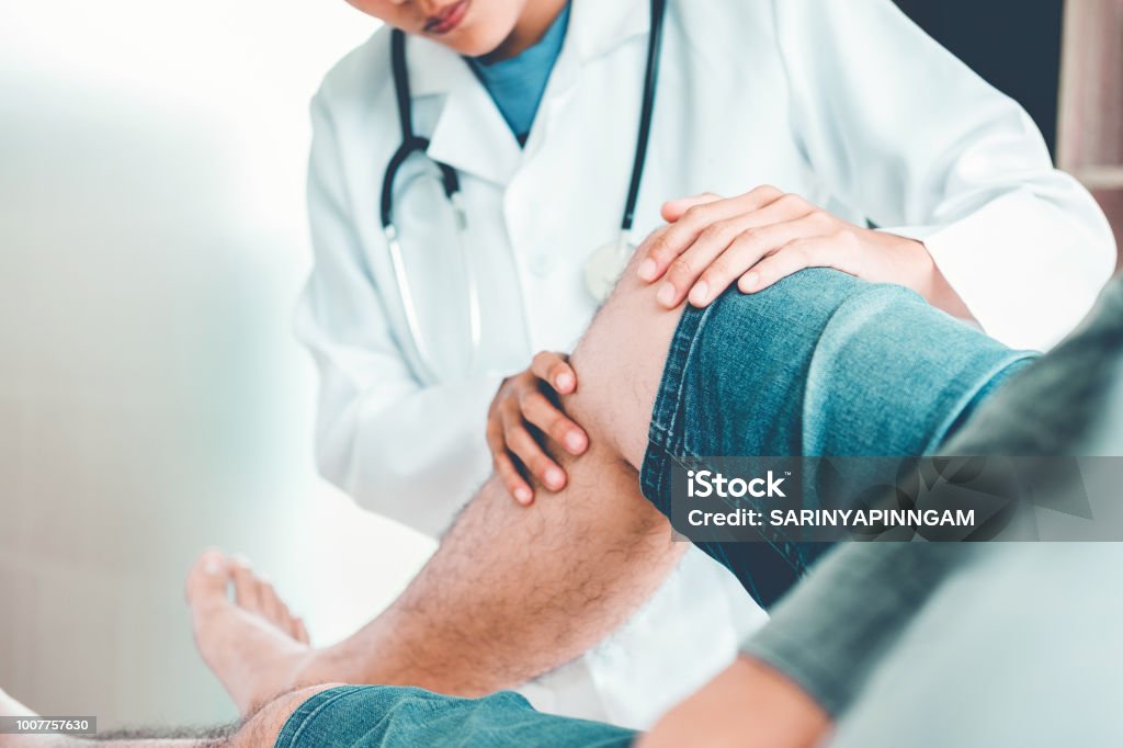 Doctor consulting with patient Knee problems Physical therapy concept Knee Stock Photo