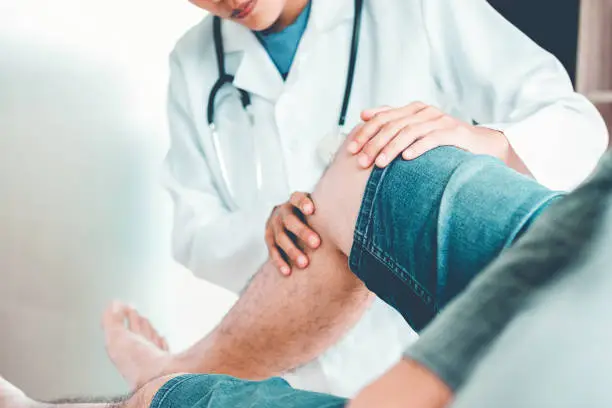 Photo of Doctor consulting with patient Knee problems Physical therapy concept