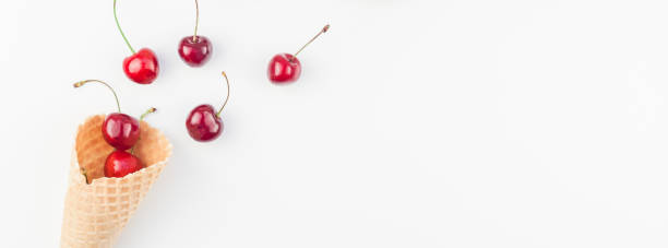 istock Ripe cherries in a waffle cone isolated 1007757918