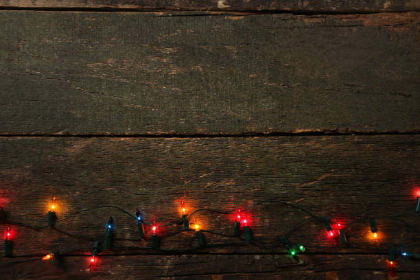 istock Christmas garland lights on grey wooden table 1007758250