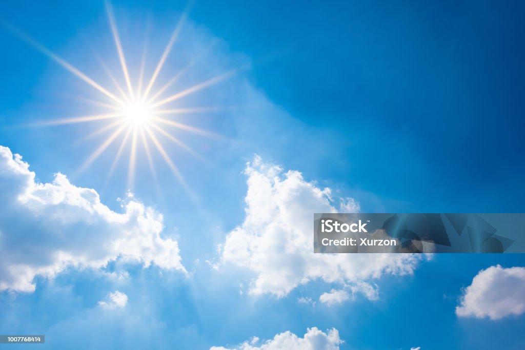 Blue sky with bright sun and clouds Sunny background, blue sky with white clouds and sun Sunny Stock Photo
